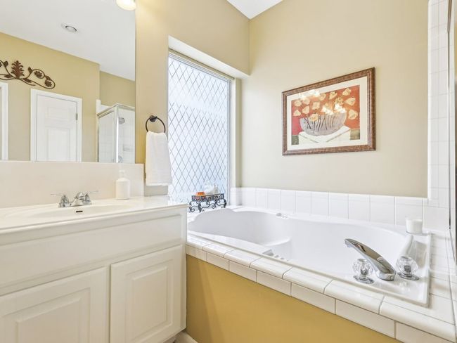 Full bath featuring a stall shower, a bath, and vanity | Image 19