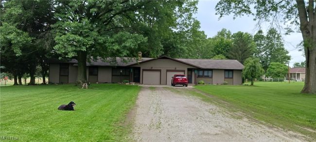 Single story home with driveway, a garage, and a front lawn | Image 26