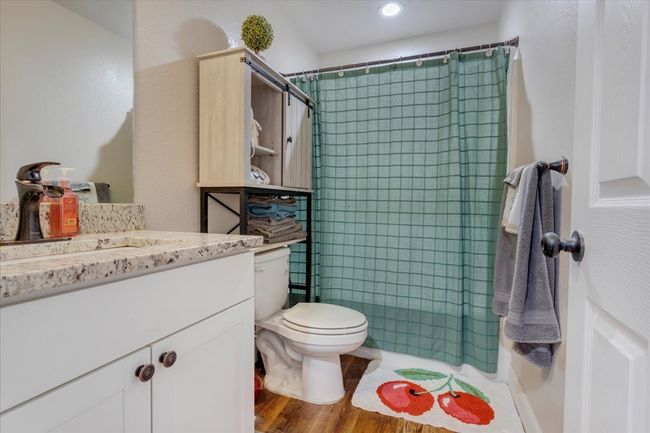 Bathroom featuring vanity, a shower with shower curtain, wood finished floors, and recessed lighting | Image 12