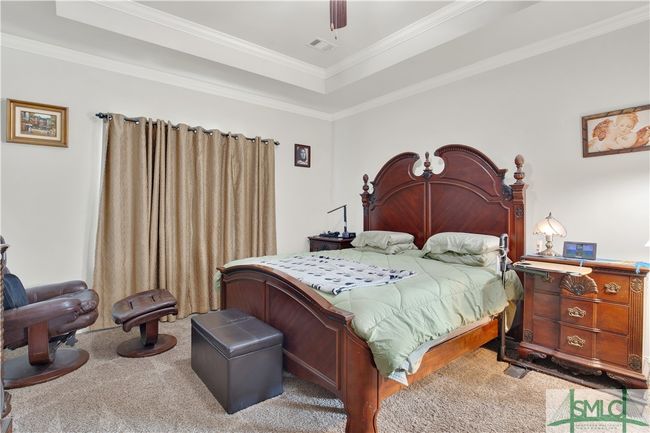 Owner's suite located on the main floor with Tray ceiling and fan | Image 18