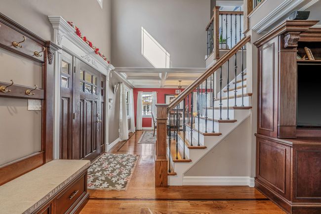 Entrance foyer featuring baseboards, light wood-style floors, and stairs | Image 11