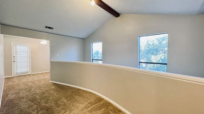 Hall with carpet, baseboards, and a textured ceiling | Image 8