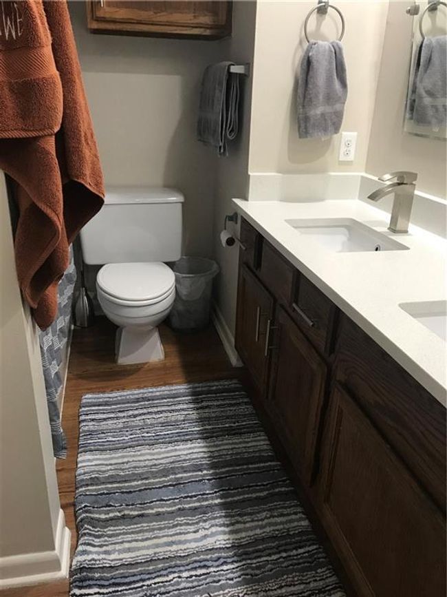 Bathroom with double vanity and wood finished floors | Image 8