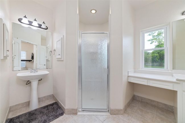 Primary bathroom with double closets, double sinks, and an oversized shower. | Image 23