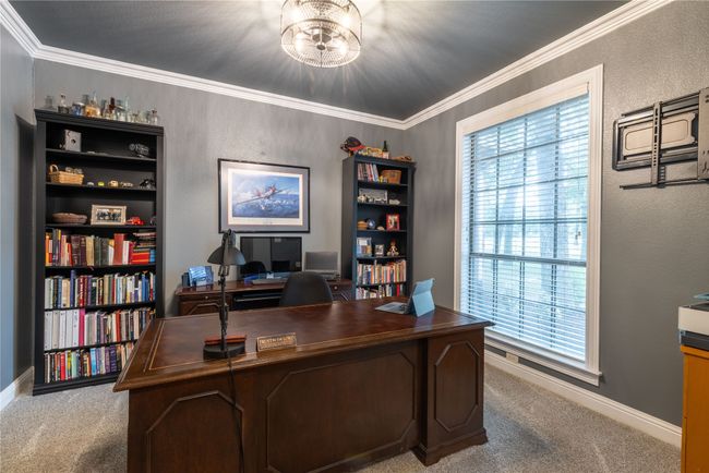 Carpeted home office or flex space featuring a chandelier and ornamental molding | Image 18