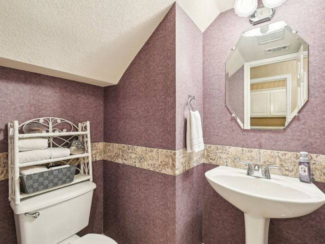 Bathroom with toilet and a sink | Image 15