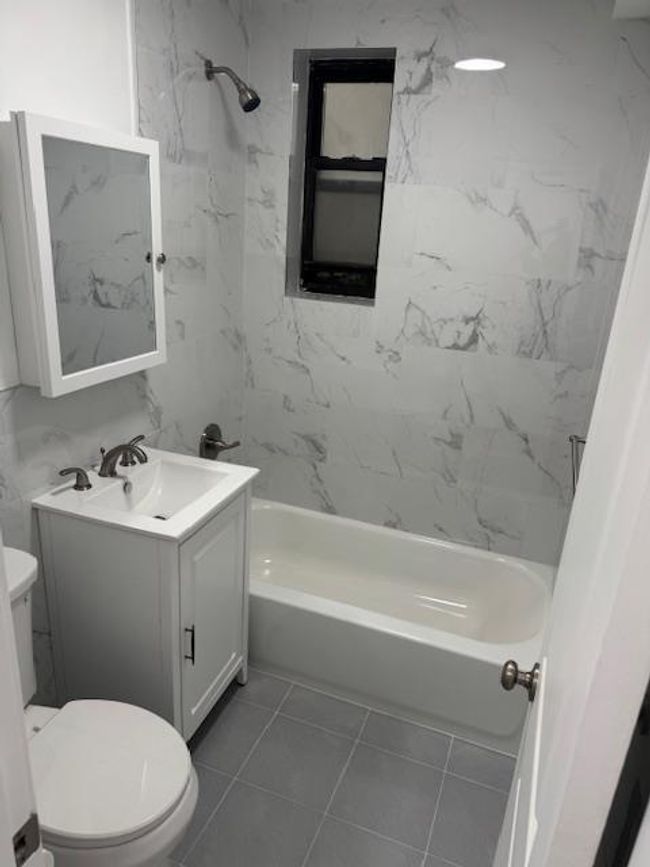 Full bath featuring vanity, shower / bathtub combination, and tile patterned floors | Image 5