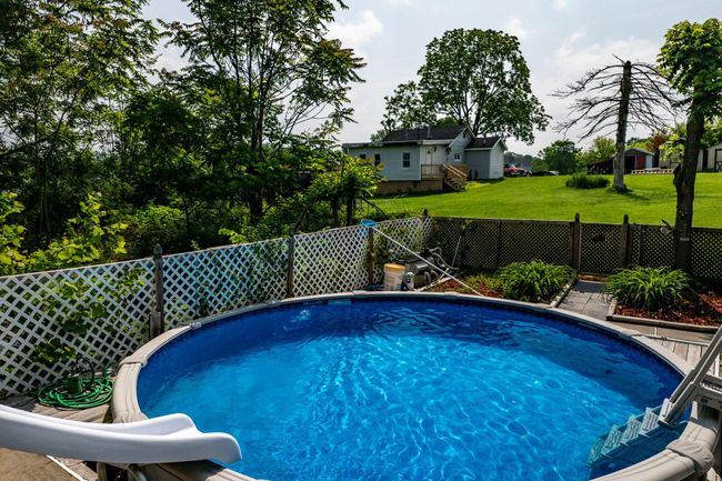 View of pool with a water slide | Image 38