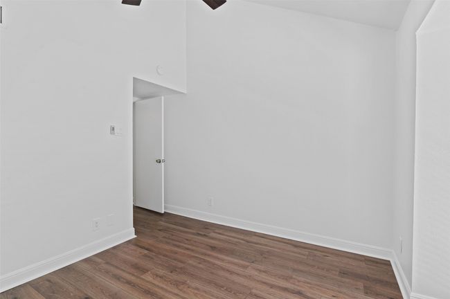 Downstairs secondary bedroom with floor to ceiling windows and brand-new flooring. | Image 18