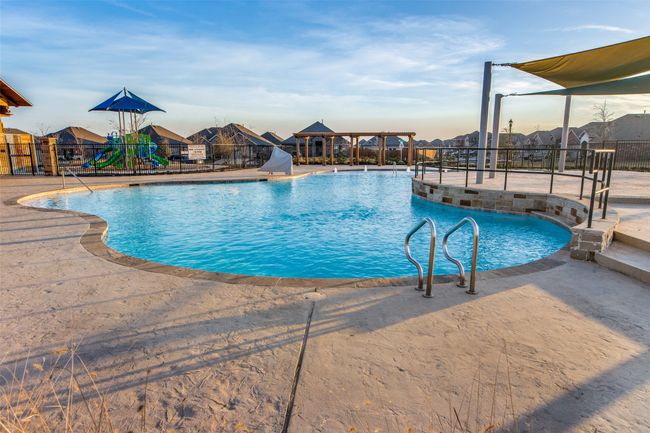 Community pool with a patio and a water​​‌​​​​‌​​‌‌​‌‌​​​‌‌​​‌‌​‌​​​​​‌ slide | Image 25