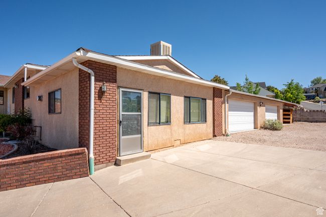 Ranch-style house featuring concrete driveway, brick siding, and stucco siding | Image 36
