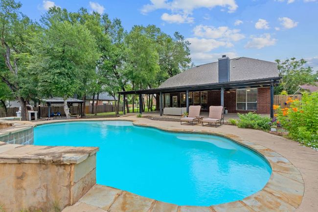 View of swimming pool with a gazebo, a fenced backyard, and a patio area | Image 4