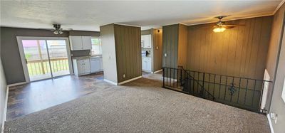 large living room area open to kitchen and dining room | Image 2