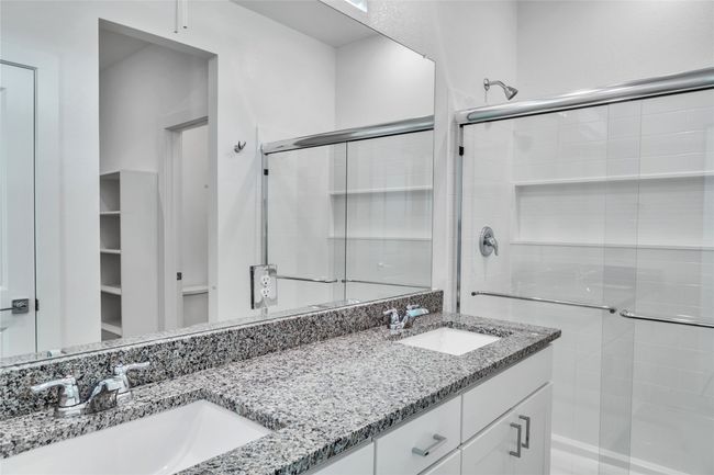 Bathroom featuring a sink, a shower stall, and double vanity | Image 6