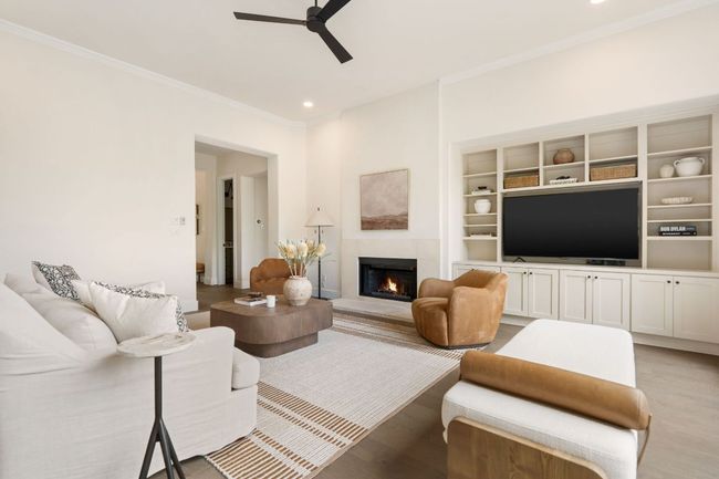 A cozy gas fireplace creates a warm and inviting focal point, ideal for gathering around on cool evenings or adding ambiance year-round. | Image 5