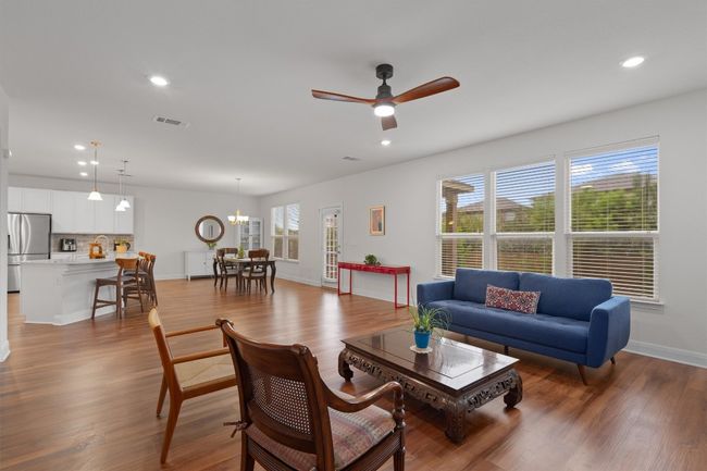 Living room featuring wood finished floors, ceiling fan, recessed lighting, and a chandelier | Image 8