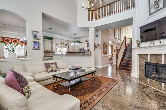 Family room features a corner fireplace. | Image 12