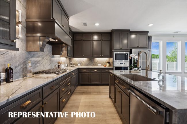 Beautiful cabinetry, gorgeous countertops, top of the line stainless steel appliances....this stunning kitchen is everything you have been searching for! REPRESENTATIVE PHOTO | Image 7