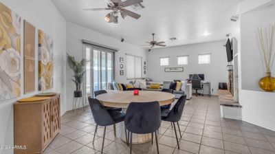 Great Room Features Dinning Area, Gas Fireplace, Ceiling Fan, Custom Shades, Surround Sound, Built-Ins and Neutral Paint and Tile. | Image 3