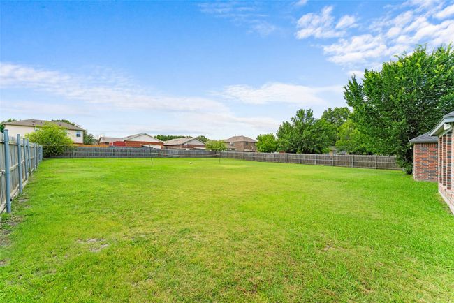View of fenced backyard | Image 27