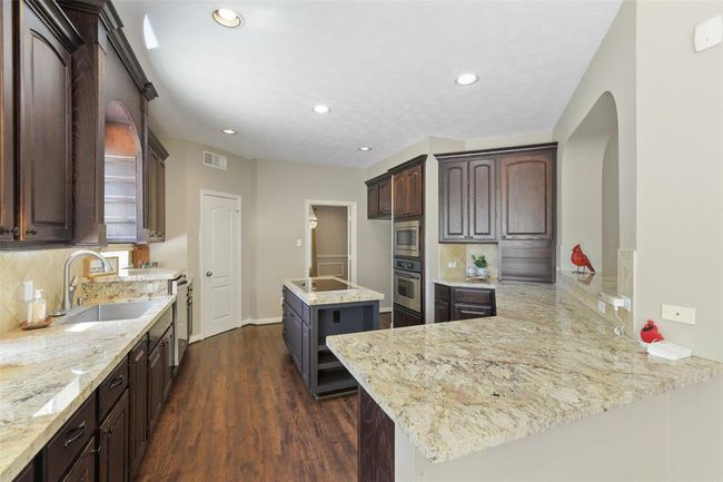 Beautiful granite, love the built-in breadbox and niche for your coffee maker. | Image 17