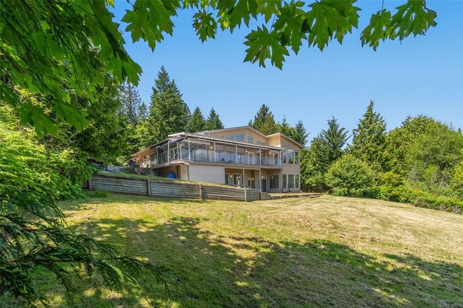Rear view of property with a sunroom and a wooden deck | Image 59