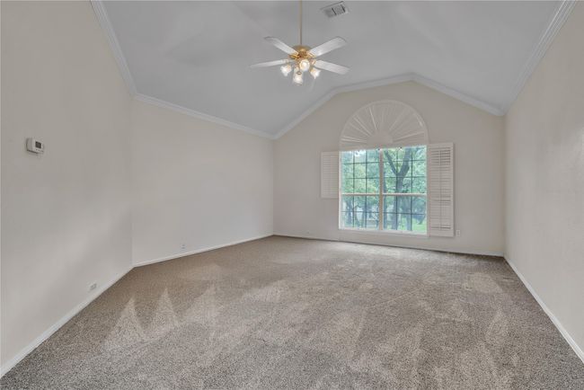 Spare room with ceiling fan, carpet flooring, crown molding, and vaulted ceiling | Image 21