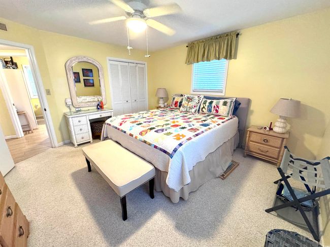 Bedroom with light carpet, a closet, and ceiling fan | Image 27