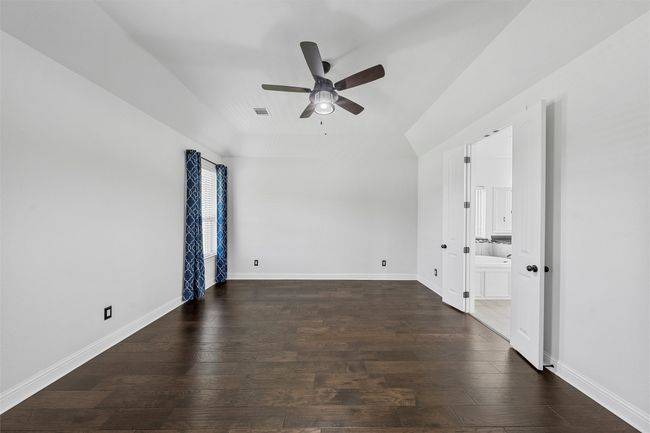 Empty room featuring a ceiling fan and wood-type flooring | Image 15