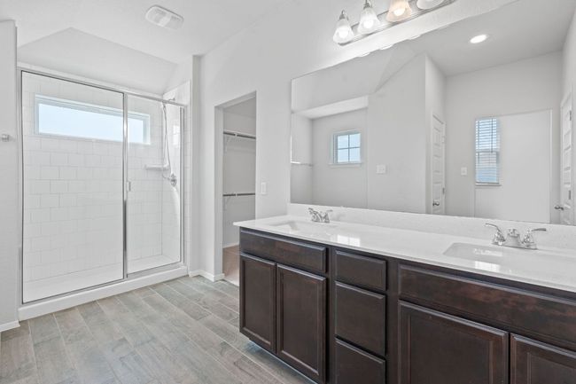 Full bath featuring a shower stall, double vanity, and a spacious closet | Image 21