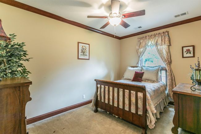 Bedroom featuring baseboards, ornamental molding, carpet floors, and visible vents | Image 18