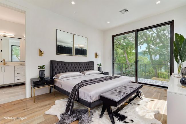 Bedroom with access to exterior, light wood-style floors, recessed lighting, and connected bathroom | Image 7