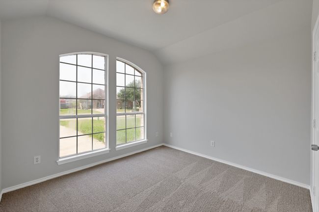 Carpeted spare room featuring vaulted ceiling, healthy amount of natural light, and baseboards | Image 13