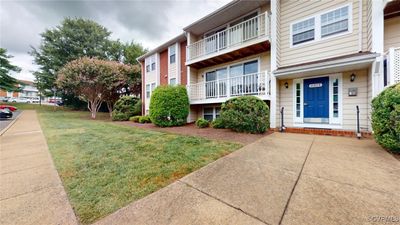 View of front of home featuring a balcony and a front yard | Image 1