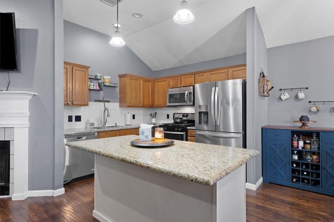 Kitchen featuring stainless steel appliances, vaulted ceiling | Image 7