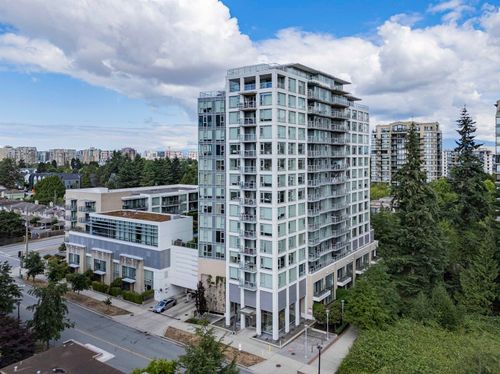 Modern high-rise residential building featuring extensive glasswork and individual balconies | Card Image