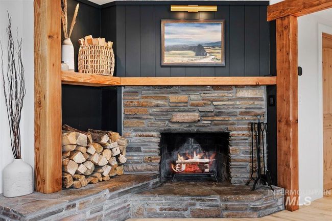 Detailed view of a fireplace and wood finished floors | Image 31