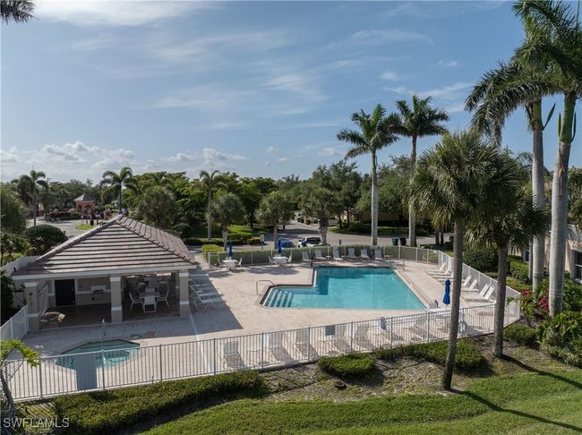 Community pool with fence and a patio | Image 31