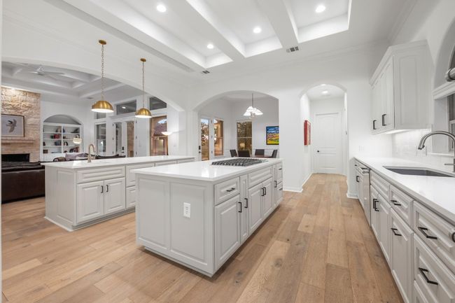Kitchen with a kitchen island, a ceiling fan, open floor plan, beam ceiling, and coffered ceiling | Image 10