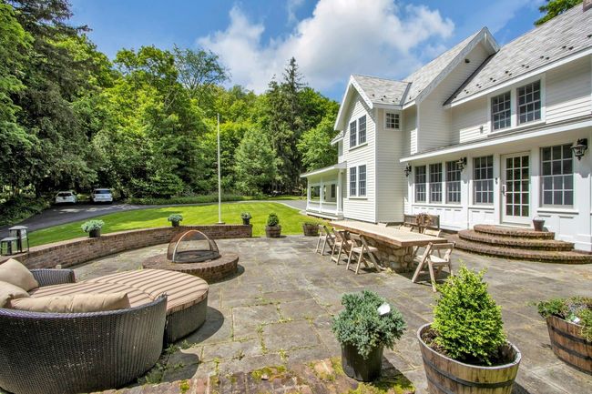 View of patio featuring an outdoor fire pit and entry steps | Image 34