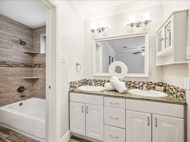 Primary bath with double sinks and separate room for toilet and tub/shower. | Image 22