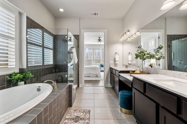 Ensuite bathroom featuring large tub, a double vanity, and a large glassed in shower | Image 23