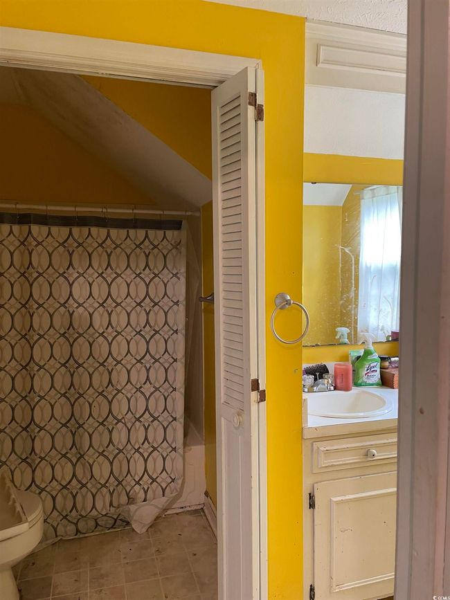 Full bathroom with vanity, shower / tub combo, and tile patterned floors | Image 30