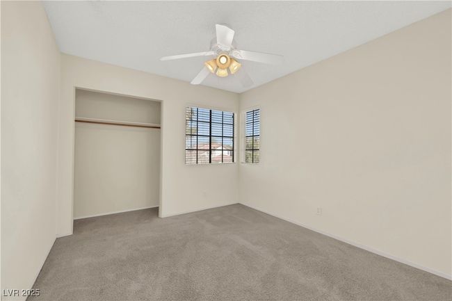 Unfurnished bedroom with a ceiling fan, a closet, light colored carpet, and baseboards | Image 28
