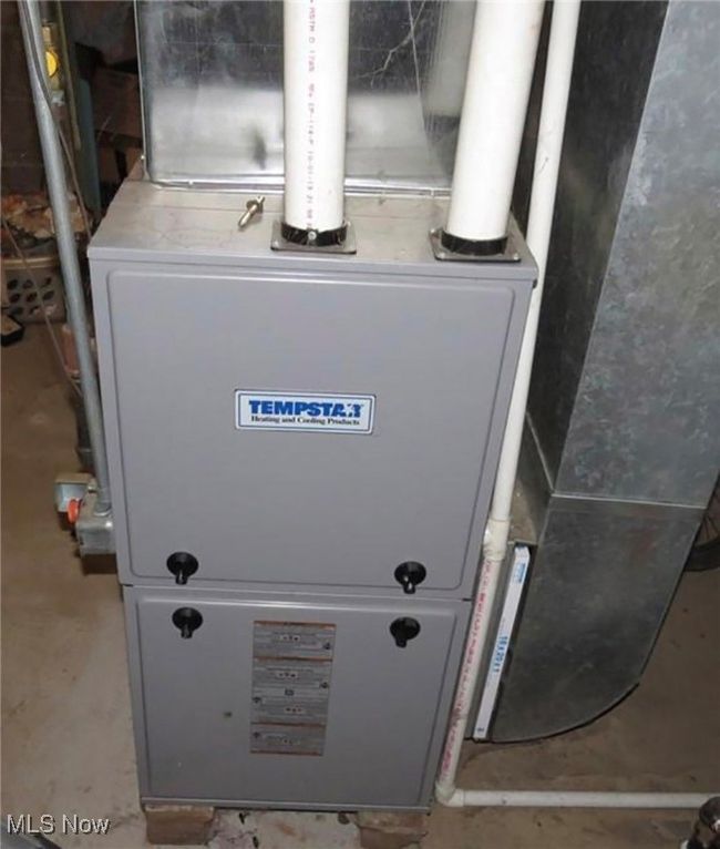 Utility room featuring heating unit | Image 13