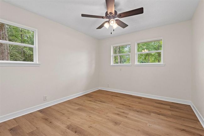 Bedroom 2 with luxury vinyl plank flooring, fresh paint, and new windows | Image 15