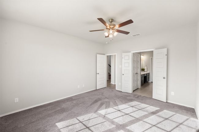 Unfurnished bedroom featuring baseboards, ensuite bath, carpet, and a ceiling fan | Image 40