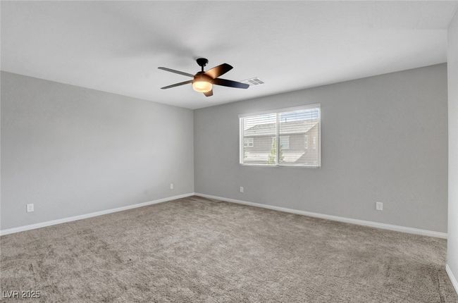Unfurnished room featuring a ceiling fan, carpet flooring, and baseboards | Image 39