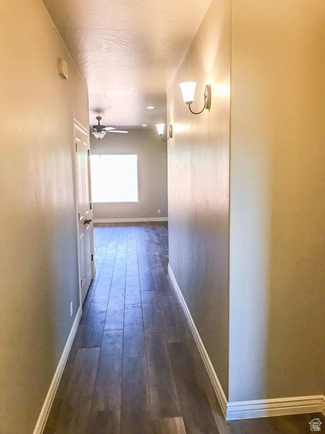 Corridor featuring baseboards and dark wood-style floors | Image 14