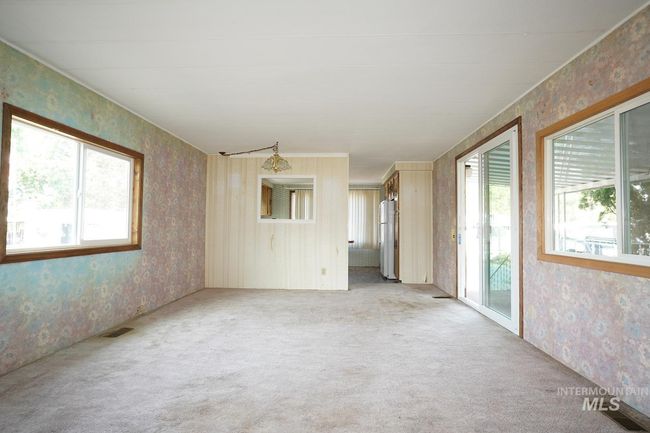 Spare room with wallpapered walls and light colored carpet | Image 8
